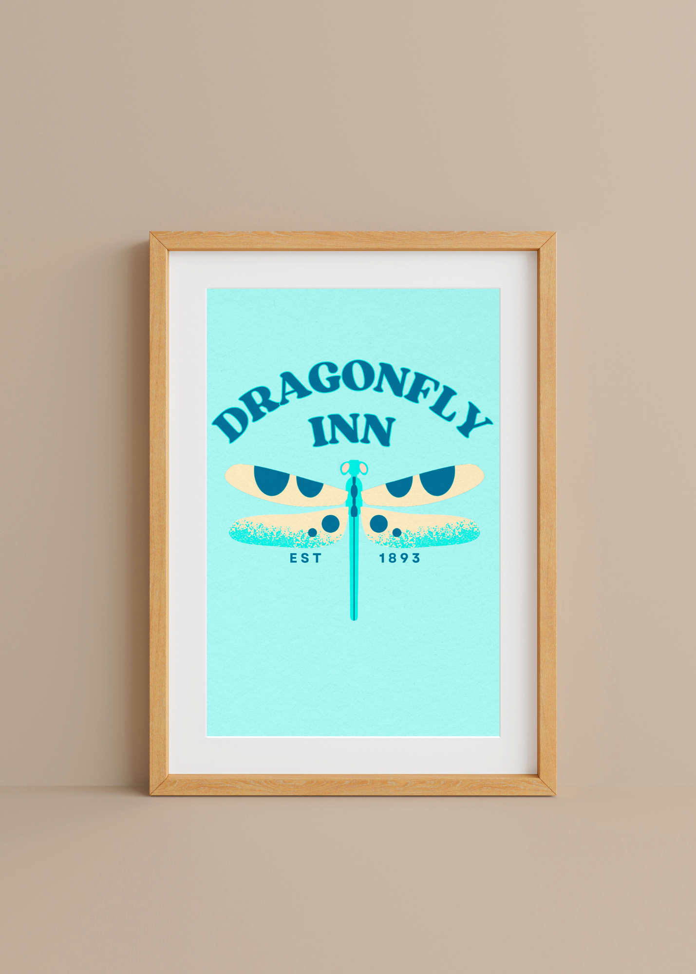 Framed artwork of 'Dragonfly Inn' with a dragonfly illustration on a light blue background.