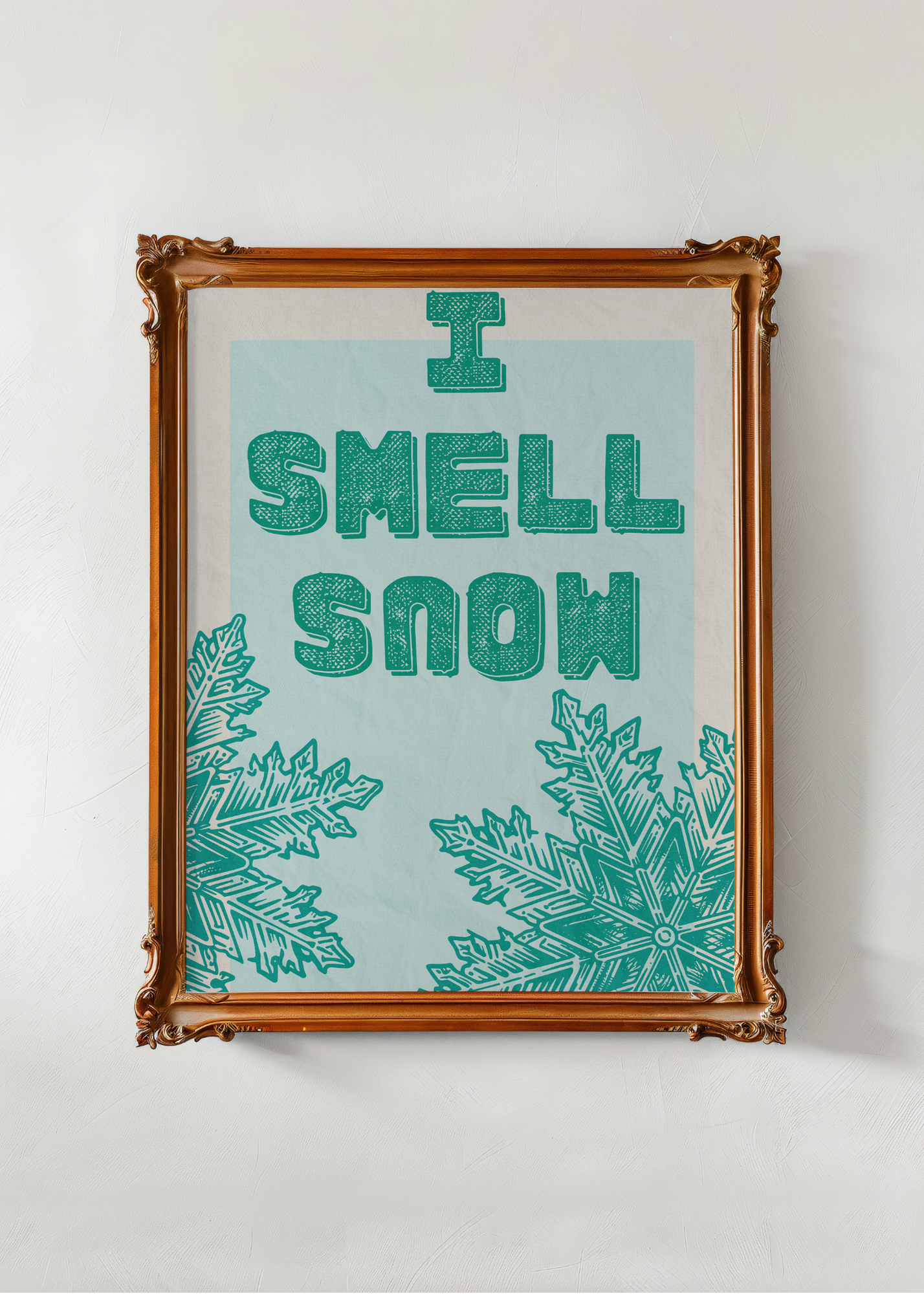 Framed artwork with 'I Smell Snow' text and snowflake designs on a light blue background.