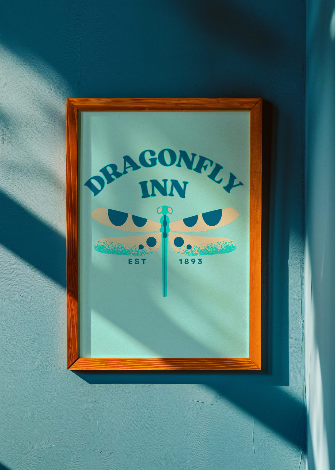 Framed artwork with 'Dragonfly Inn' text and logo on a teal background
