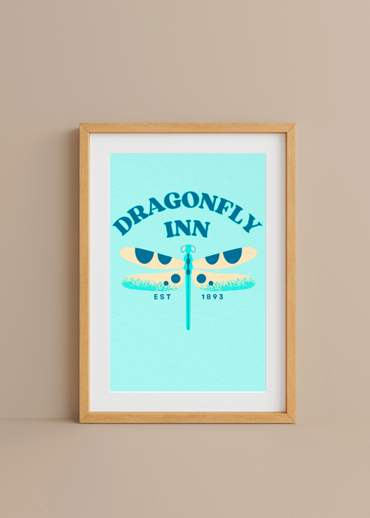 Framed artwork of 'Dragonfly Inn' with a dragonfly illustration on a light blue background.