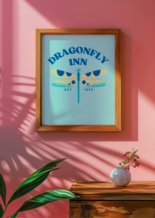 Framed artwork with 'Dragonfly Inn' design on a pink wall.