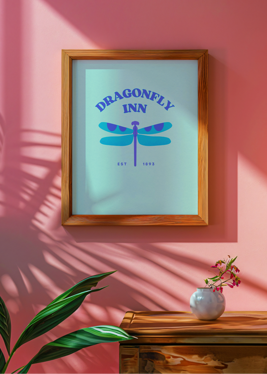 Framed artwork with 'Dragonfly Inn' design on a pink wall.