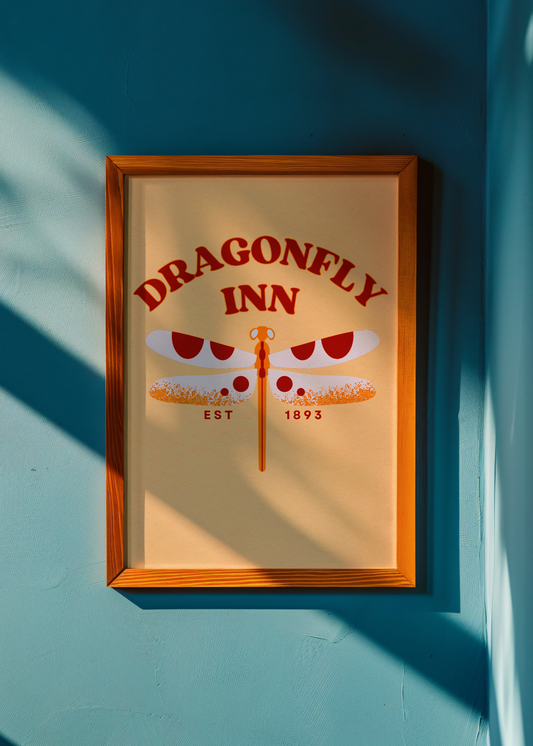 Framed poster of the Dragonfly Inn logo on a blue wall