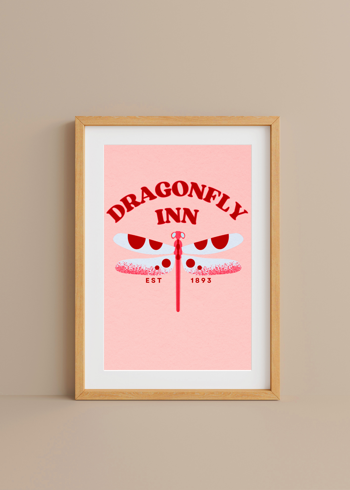 Framed poster of 'Dragonfly Inn' with a pink background and wooden frame.